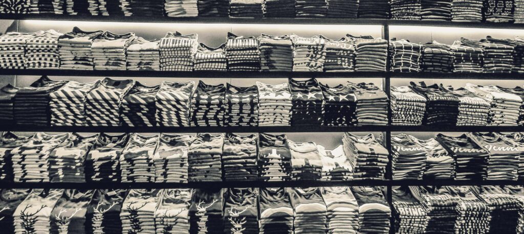 image shows row and rows of stacked tshirts, illustrating overproduction of tshirts in the USA